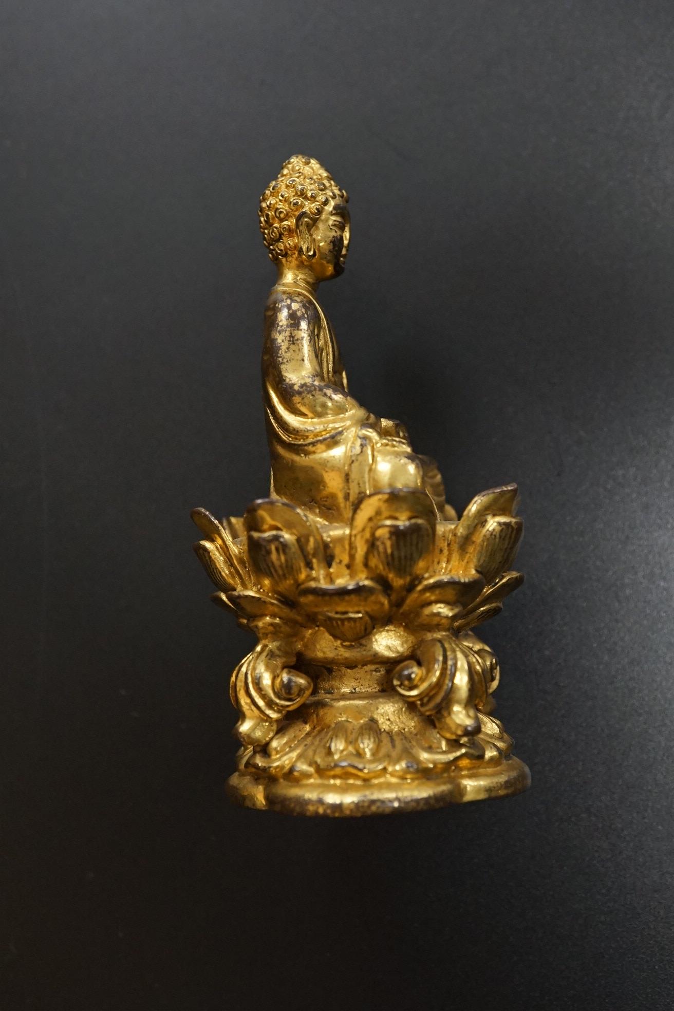 A Chinese miniature gilt metal figure of seated Buddha, 8cm high